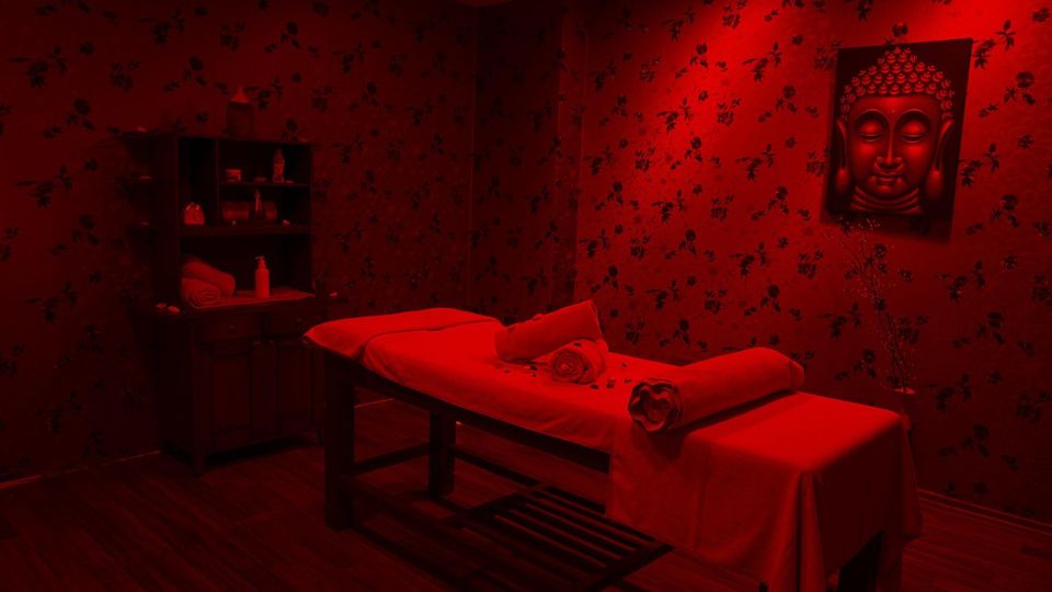 Massage bed in a room under a red light.