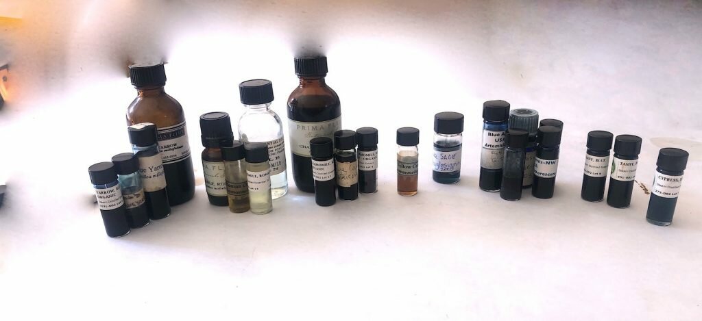 Several Examples of 8 different blue  oils, 21 bottles in all.